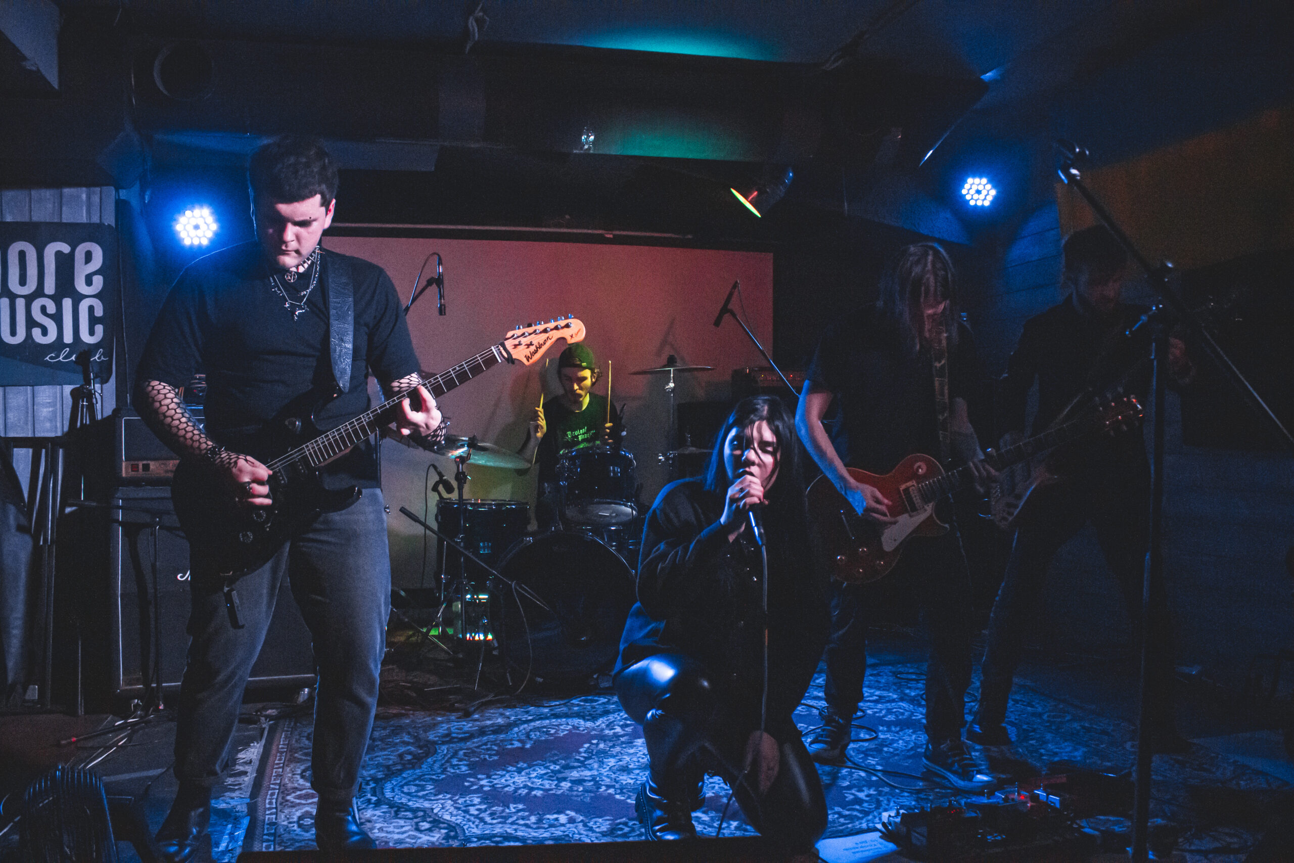 An expressive live performance on stage by the band Deviant Blaze.